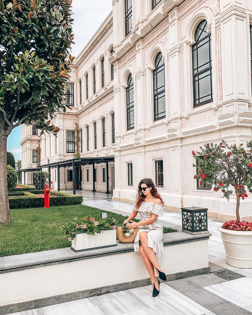 Off shoulder dress with half moon straw bag